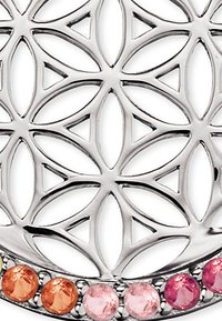 Sølvsmukkeri har et geometrisk design med cirkulære udskæringer og en række farverige ædelstene i orange og pink nederst.