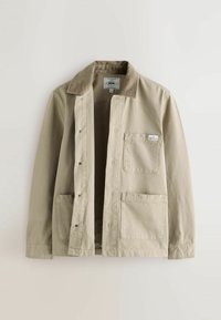 Beige cotton jacket with a corduroy collar, snap buttons, two front pockets, and a label on the left pocket. Lightweight and casual design.