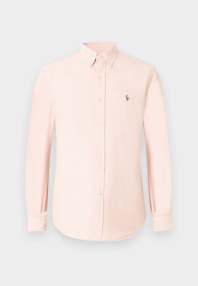Light pink button-up shirt made of soft fabric, featuring a classic collar, long sleeves, and a small embroidered logo on the left chest.