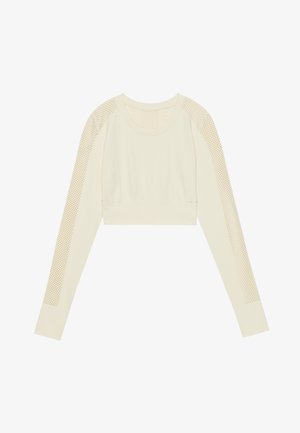 Crop top beige clair fabriqué en tissu texturé, avec des panneaux en maille sur les épaules et les manches. Encolure arrondie, manches longues.
