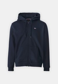 Sudadera con cremallera en color marino, con capucha ajustable mediante cuerda, puños acanalados, dos bolsillos frontales y un pequeño logotipo en el lado izquierdo del pecho. Textura de tela suave.