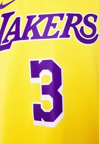 Camiseta de baloncesto amarilla con "LAKERS" en letras moradas y el número "3" en blanco y morado en negrita. Tejido de malla texturizado.