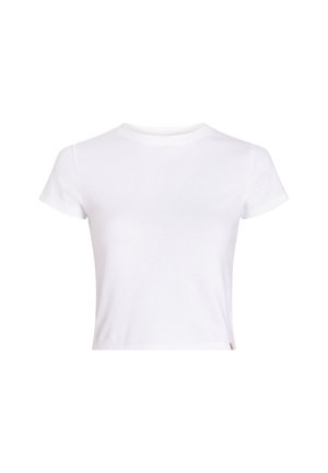 Biała bawełniana koszulka z krótkim rękawem, okrągłym dekoltem i skróconym krojem, z minimalnymi detalami i małą metką z logo na brzegu.