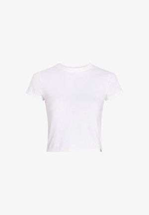Biała bawełniana koszulka z krótkim rękawem, okrągłym dekoltem i skróconym krojem, z minimalnymi detalami i małą metką z logo na brzegu.