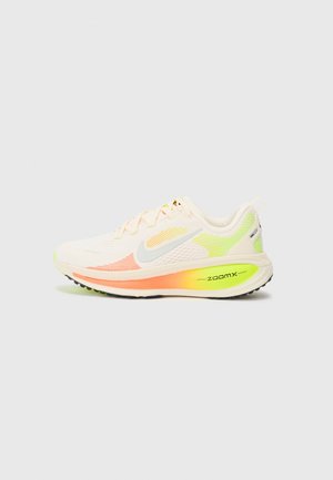 Lightweight athletic shoe in cream, featuring a textured mesh upper with pastel gradient accents in yellow and pink, and a prominent orange heel.