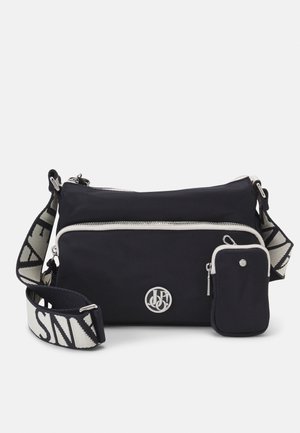 Navy crossbody bag made of nylon, featuring a silver logo, a front zip pocket, and a detachable pouch with a zip closure. Strap has pattern accents.