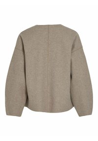 Pull en laine oversize beige avec un col rond, des épaules tombantes et une couture dans le dos. Tissu doux et texturé.