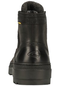 Black ankle boots featuring a smooth leather exterior, textured mesh panel, and a sturdy rubber sole with pronounced tread.