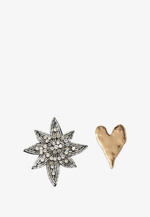 Two brooches: a silver star-shaped design with rhinestones and a gold heart-shaped brooch with a smooth, slightly textured surface.