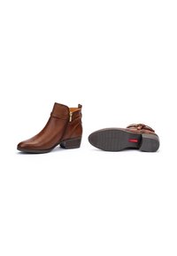 Brown leather ankle boots with a side zipper and decorative strap. Slightly textured surface and a low block heel for stability.