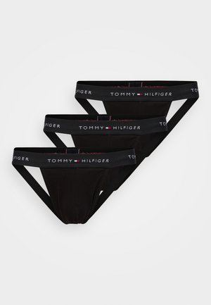 Tre svarte herreunderbukser fra Tommy Hilfiger med merkede elastiske midjebånd, lagt flatt mot en hvit bakgrunn.