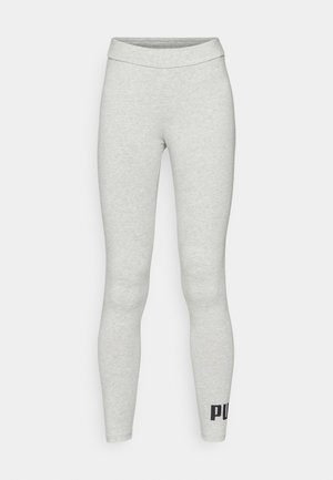 Leggings griși deschiși din material elastic, cu un talie înaltă. Prezintă un grafic cu logo negru pe piciorul inferior. Textură netedă, design ajustat.