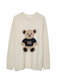 Cremefärgad stickad tröja med en teddybjörn som bär en svart tröja med siffran 10 i mitten.