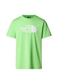 Camiseta de algodón verde brillante con mangas cortas, que presenta un gran logotipo en blanco de "THE NORTH FACE" y un gráfico curvado en la parte frontal.