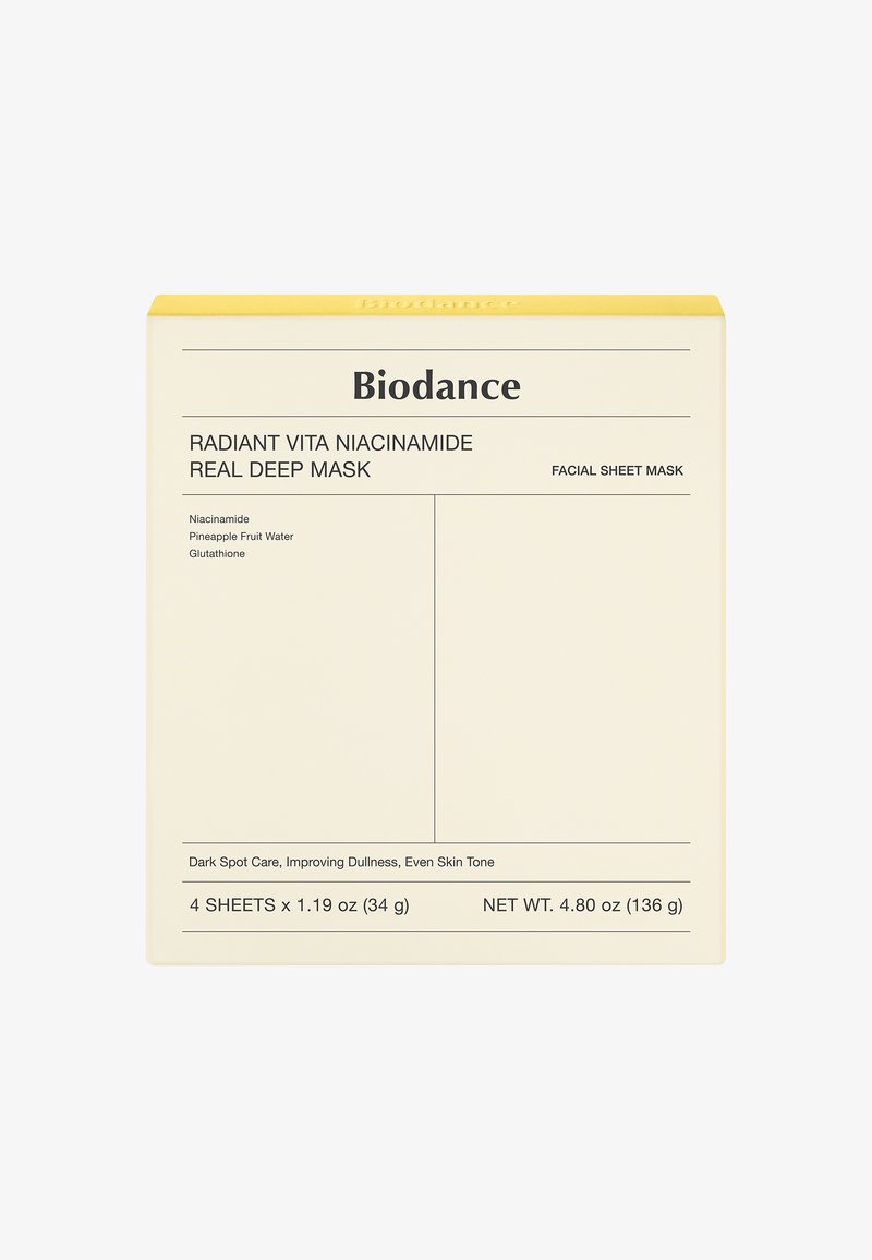 Scatola di maschere facciali con uno sfondo crema e una parte superiore gialla, con testo nero che dettaglia gli ingredienti e le informazioni sull'uso.