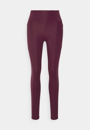 Leggings bordeaux en matière extensible, avec une taille haute, une texture lisse et une coupe ajustée. Pas de motifs visibles ni de détails matériels.
