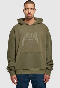 Olive green hooded sweatshirt with a front pocket, ribbed cuffs, and textured fabric. Features bold white graphic text on the chest.
