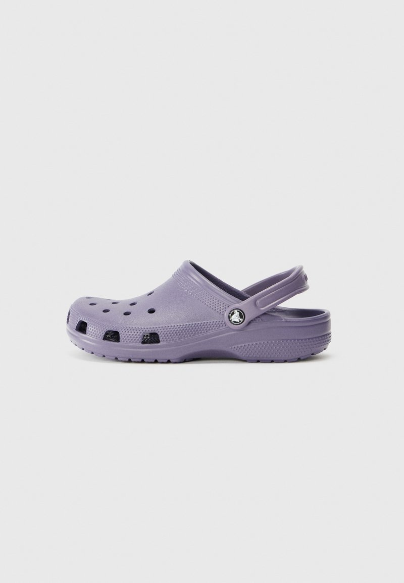 Purple clogs made of lightweight material, featuring ventilation holes, a back strap, and a textured sole with a silver logo accent.