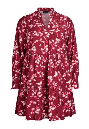 Abito rosso floreale con motivi bianchi, scollatura a V, maniche lunghe, design a strati e vestibilità comoda. Realizzato in un tessuto leggero.