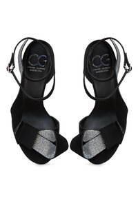 Black high-heeled sandals with a suede upper, metallic mesh accents, and a strap around the ankle, featuring a closed toe design.