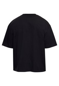 T-shirt noir uni à manches courtes, vu de dos avec un col rond et une coupe décontractée sur fond blanc.