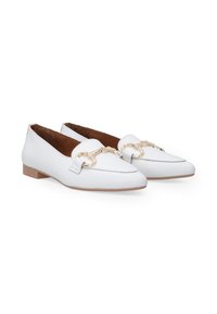 White leather loafers with a flat sole, featuring a gold chain accent across the front and a smooth texture. Classic design and finger loop.