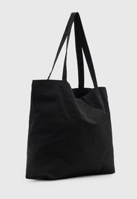 Borsa a tracolla nera con due manici lunghi, realizzata in un tessuto testurizzato, dotata di un ampio scomparto principale e di un design minimalista.