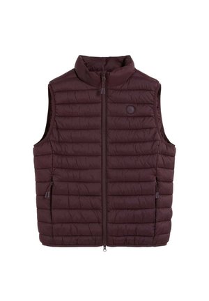 Chaleco sin mangas acolchado de color marrón oscuro con cuello alto y cremallera frontal, con dos bolsillos laterales con cremallera y un pequeño logo circular en el pecho.