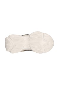 La semelle extérieure de la chaussure présente une semelle en caoutchouc blanc texturé avec des motifs en zigzag et des sections contourées pour une adhérence et une flexibilité optimales.