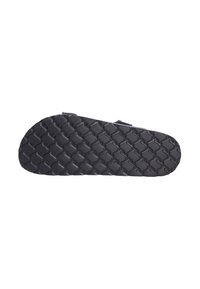 Zwarte sandalenzool met een dikke, gestructureerde diamantpatroon voor grip, gezien van onderen op een witte achtergrond.