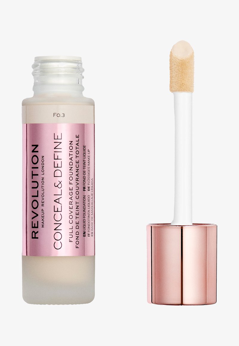 Fond de teint liquide à couverture complète dans un flacon en verre givré avec une étiquette rose. Applicateur blanc avec une pointe douce et un capuchon réfléchissant en rose doré.