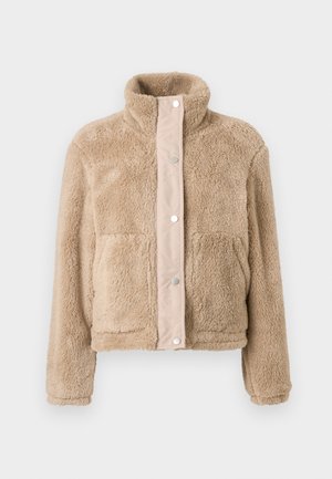 Beige fleece jacket with snap buttons, high collar, long sleeves, and two front pockets, displayed on a plain white background.