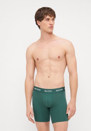 Groene katoenen boxershorts met een aansluitend ontwerp en een zwarte tailleband met het "HOLLISTER"-logo in het wit. Zorgt voor een soepele textuur.