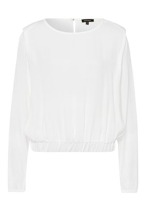 Hvid bluse med lange ærmer, rund halsudskæring, elastisk talje og lille lynlås bagpå, lavet af let stof.