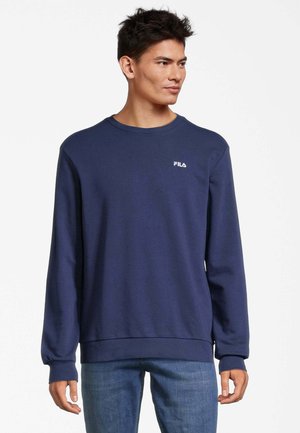 Felpa blu navy con maniche lunghe, polsini a costine e scollatura a girocollo. Presenta un logo FILA bianco sul petto. Texture liscia.