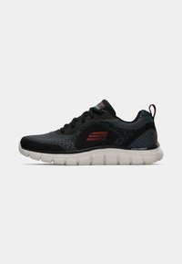 Black and grey athletic shoe with a mesh upper, textured pattern, supportive sole, and red accent logo. Lightweight design with cushioning.