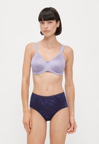 Light purple bra with a textured surface and center bow, paired with dark blue high-waisted underwear featuring a floral pattern.