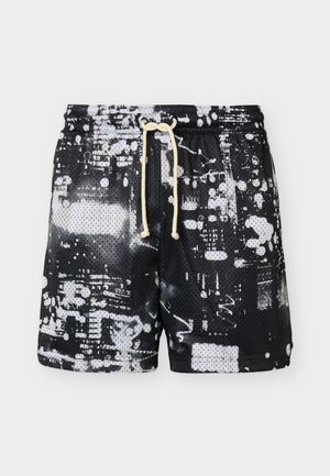 Sorte meshshorts med hvidt abstrakt malersprøjtmønster og beige snøre i taljen, fladt lagt på lys baggrund.