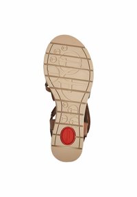Sandale marron avec une semelle en caoutchouc texturé de couleur beige, dotée d'un accent circulaire rouge et d'un motif de semelle circulaire pour une meilleure adhérence.
