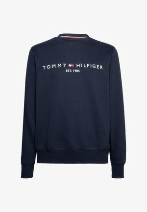 Sweatshirt bleu marine avec col rond, poignets et ourlet côtelés, arborant le texte blanc du logo "TOMMY HILFIGER EST. 1985" sur le devant.