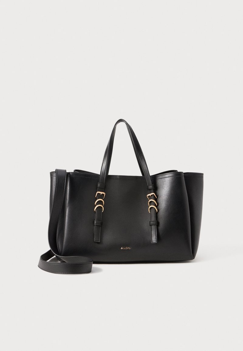 Schwarze Leder-Tote mit zwei Griffen und einem abnehmbaren Schultergurt. Goldfarbene Hardware-Details und flacher Boden für Stabilität.