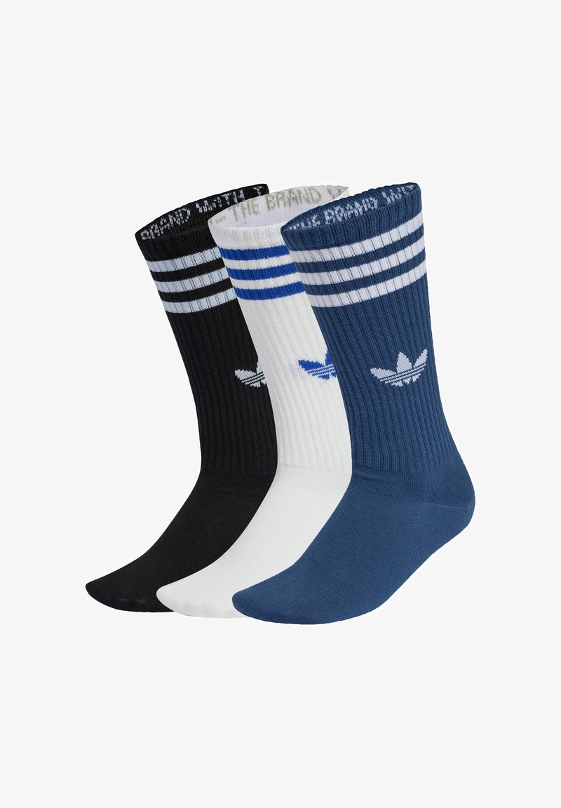 Drei Paar Crew-Socken: schwarz mit weißen Streifen, weiß mit blauen Streifen und dunkelblau. Jede Socke hat eine gerippte Textur und ein Logo.