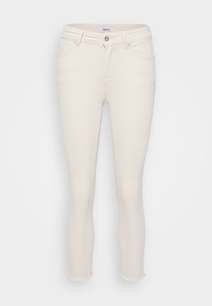 Cream-colored skinny jeans with a frayed hem. Made of denim with a classic five-pocket design and a front button closure.