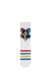 Calzini bianchi con un logo multicolore di Hogwarts. Accentuati da strisce orizzontali rosse, blu, gialle e verdi nella parte inferiore.