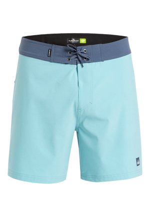 Light blue swim shorts with a dark blue waistband, featuring a front tie closure and side pocket, made of smooth, lightweight material.