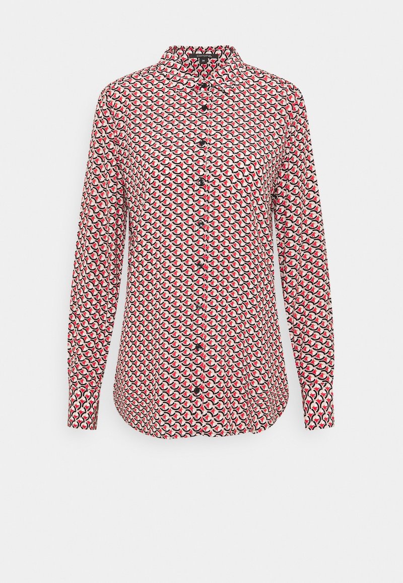 Chemise à manches longues blanche avec un motif circulaire rouge et noir, dotée d'un devant boutonné et d'un petit col. Fabriquée à partir d'un tissu lisse.