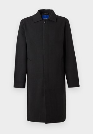 Zwarte lange herenjas met kraag, verborgen knoopsluiting en zijzakken, afgebeeld tegen een effen lichte achtergrond.