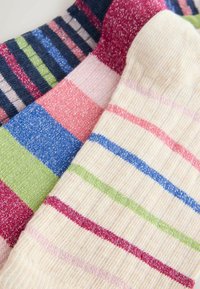 Drei Paar Socken mit verschiedenen gestreiften Mustern in Farben wie Pink, Grün, Blau und Creme, mit einer dezenten, glänzenden Textur.