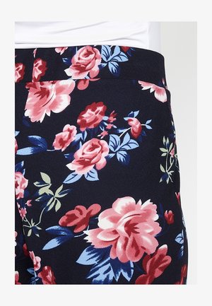 Tissu bleu marine avec un motif floral comprenant de grandes roses roses et rouges, des feuilles bleues et des accents verts. Texture lisse avec une taille élastique.
