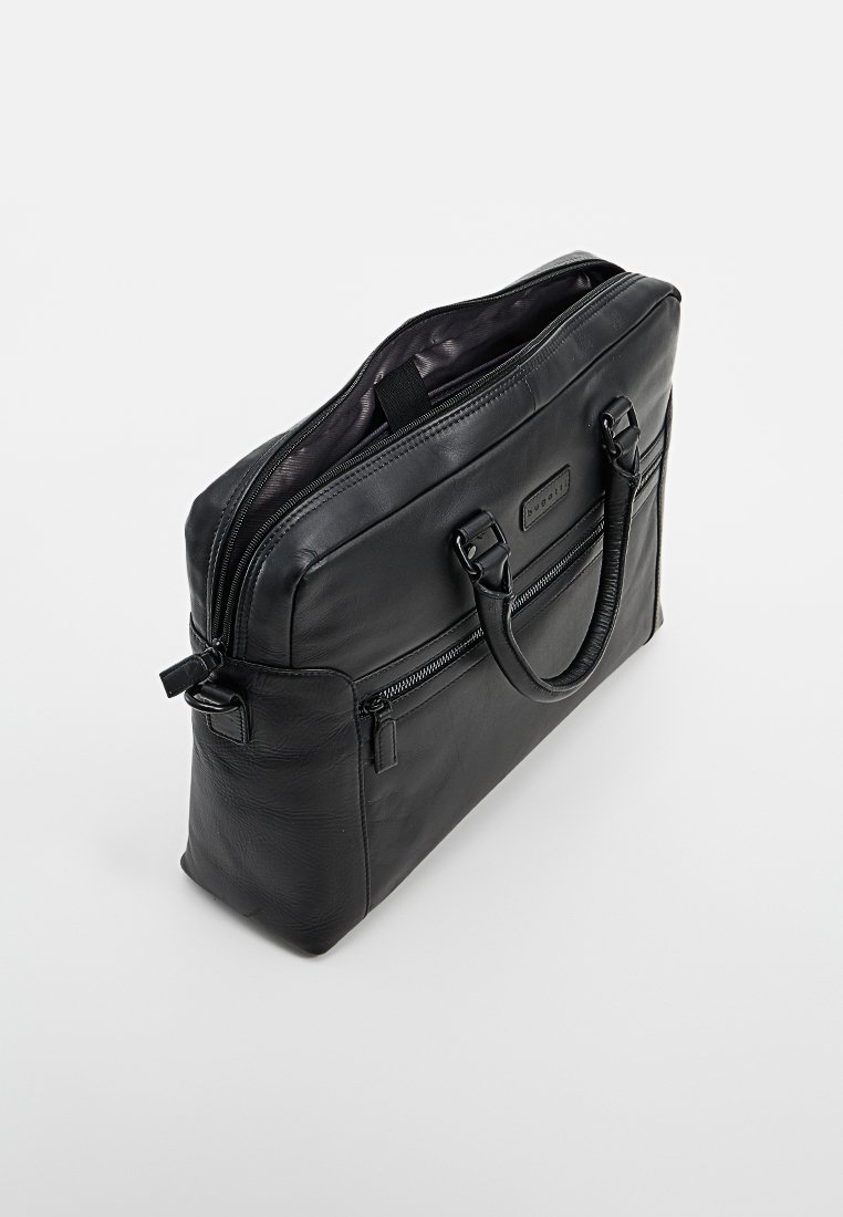 Malette en cuir noir avec double poignée, poche zippée à l'avant et compartiment principal partiellement ouvert montrant un revêtement en tissu sombre.